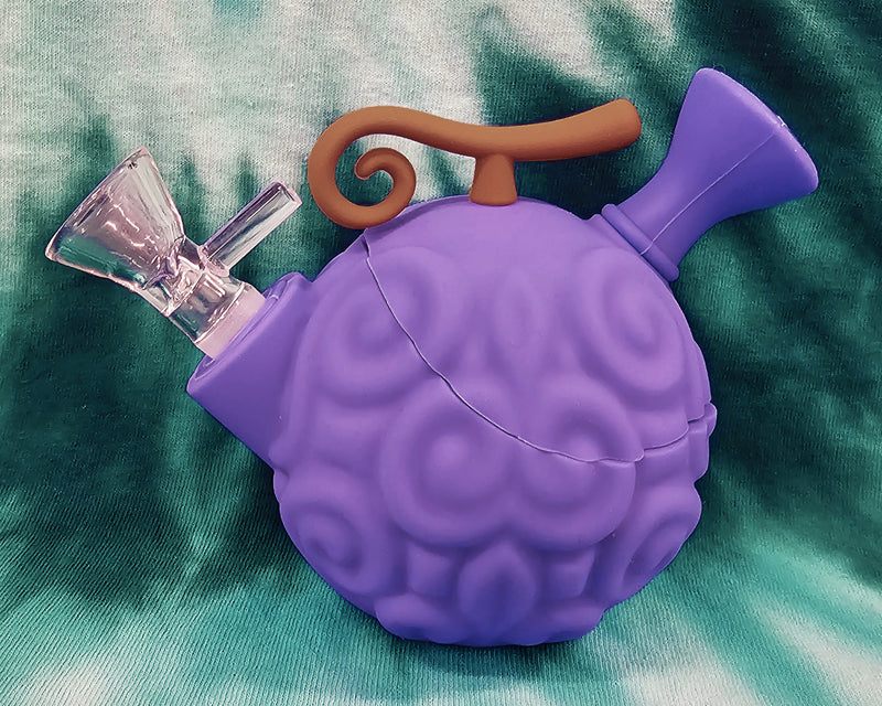 Purple devil fruit silicone water pipe angled to show the glass bowl and curled gold stem