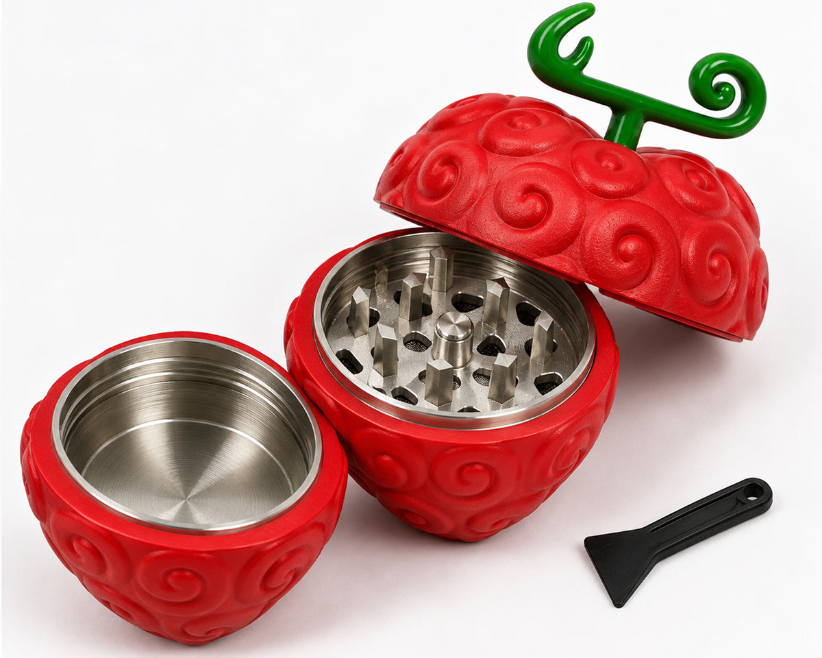 Red heart grinder open to show metal grinding teeth, lower chamber, and black scraper